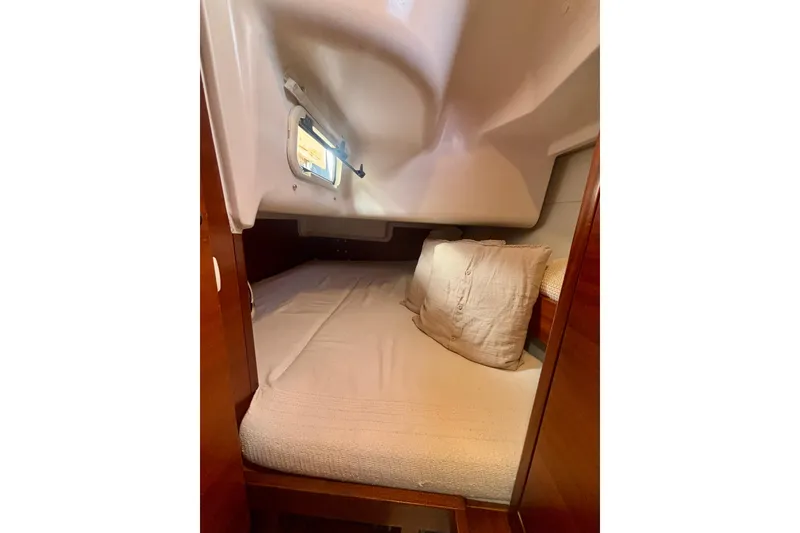 Slide: The Image of Cozy cabin interior of 2015 Salona 35 sailboat with bed and window. - 39