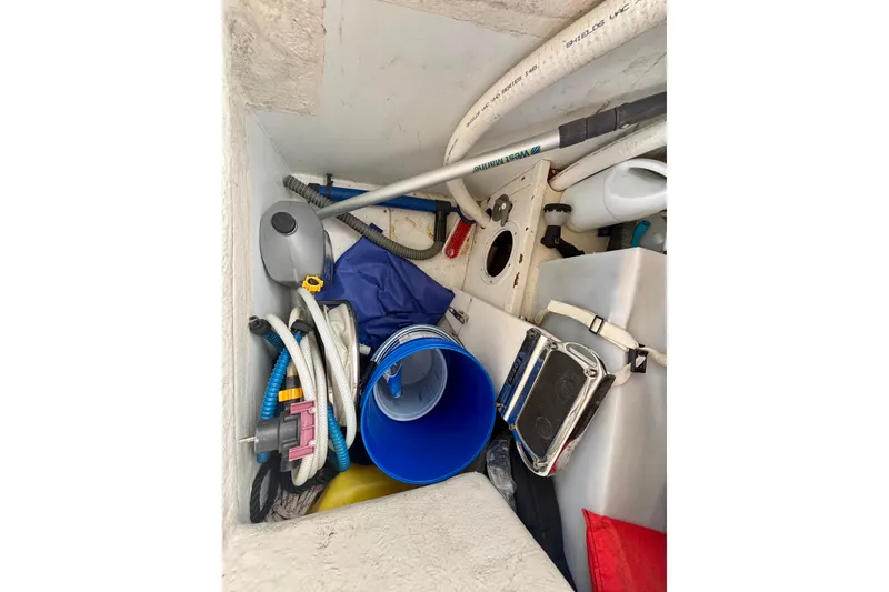 Slide: The Image of Storage compartment of a 2015 Salona 35 sailboat with various equipment and tools. - 43