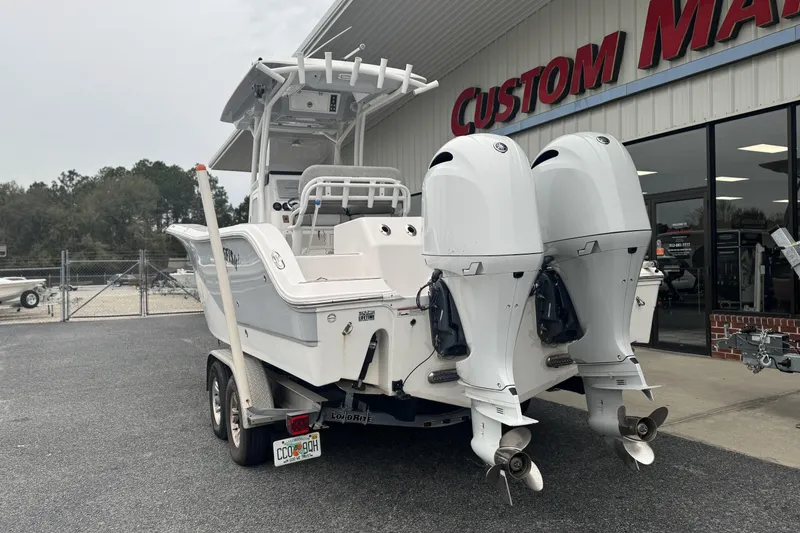 Slide: The Image of 2018 Sea Fox 268 Commander boat with dual engines on a trailer outside a dealership. - 3