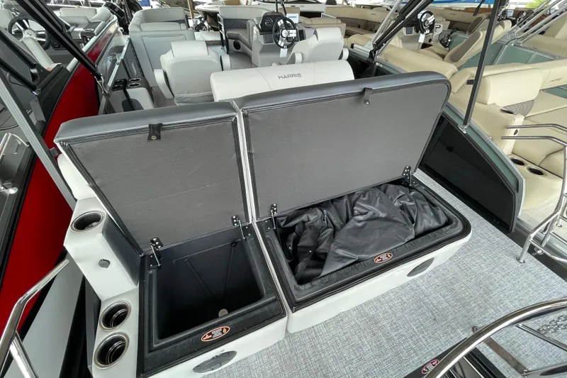 Slide: The Image of 2026 Harris Cruiser 230 boat interior with open storage compartments and seating area. - 17