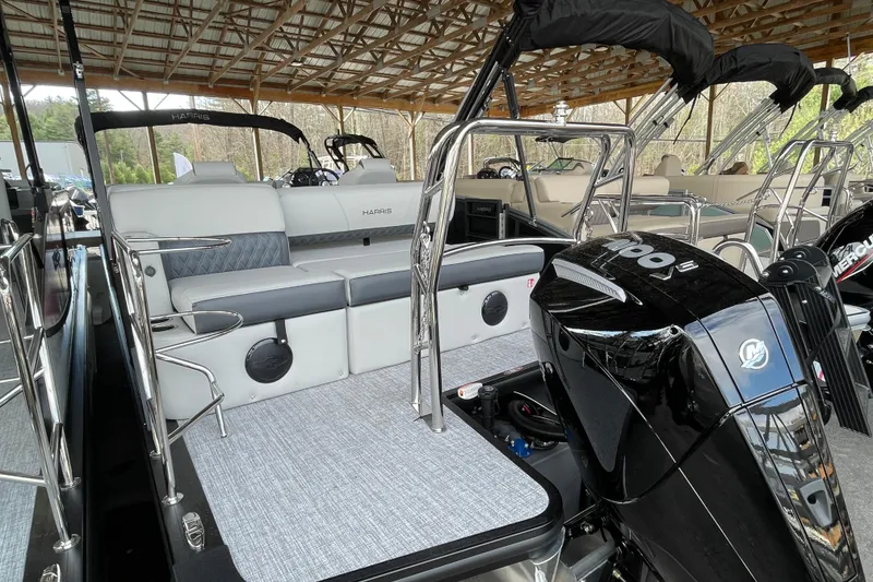 Slide: The Image of 2026 Harris Cruiser 230 pontoon boat with sleek seating and powerful Mercury outboard engine. - 18