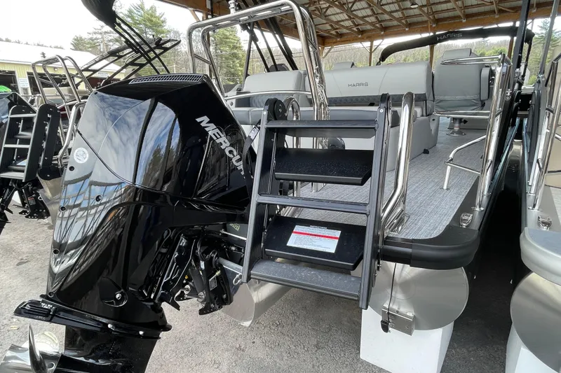 Slide: The Image of 2026 Harris Cruiser 230 pontoon boat with Mercury engine and boarding ladder. - 19