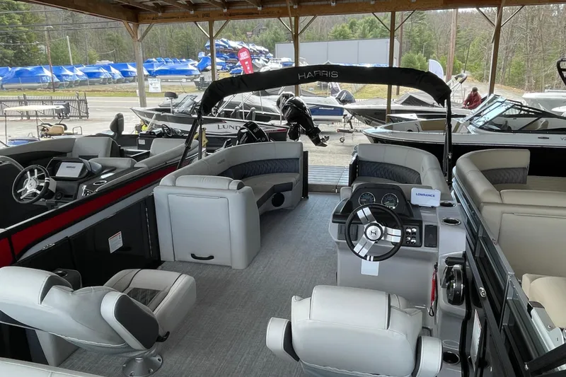 Slide: The Image of 2026 Harris Cruiser 230 pontoon boat interior with modern seating and steering console. - 4