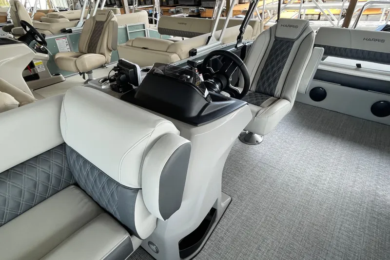 Slide: The Image of 2026 Harris Cruiser 230 interior with luxurious seating and modern steering console. - 8