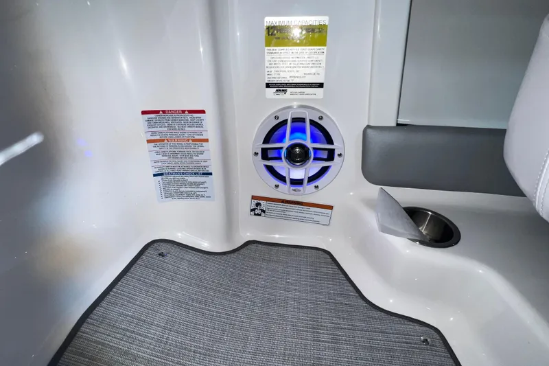 Slide: The Image of Interior of 2021 Chaparral 21 SSi boat with speaker and safety labels. - 21