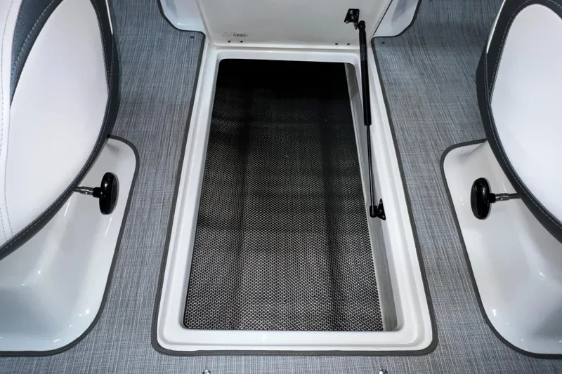 Slide: The Image of 2021 Chaparral 21 SSi boat interior storage compartment with open hatch. - 23