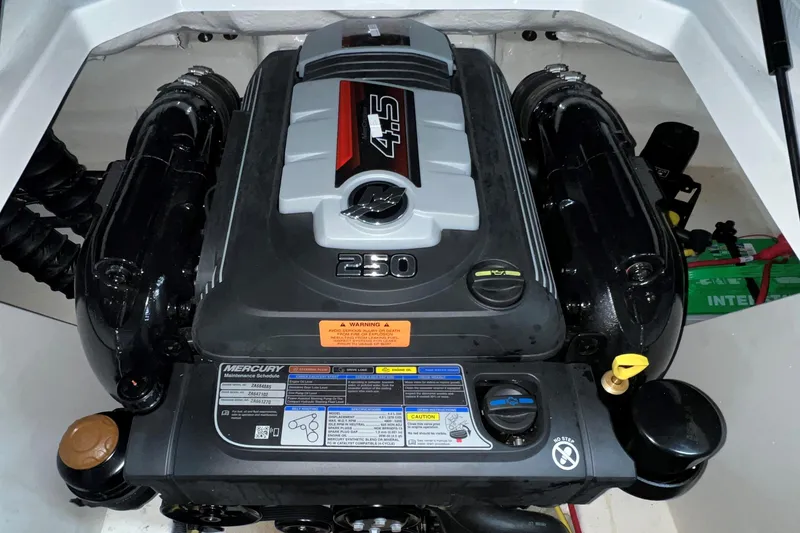 Slide: The Image of Engine compartment of a 2021 Chaparral 21 SSi boat, featuring a Mercury 4.5L engine. - 25