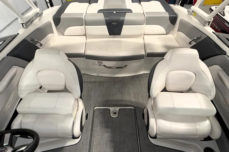 Slide: The Image of 2021 Chaparral 21 SSi boat interior with white and gray seating, modern design. - 4