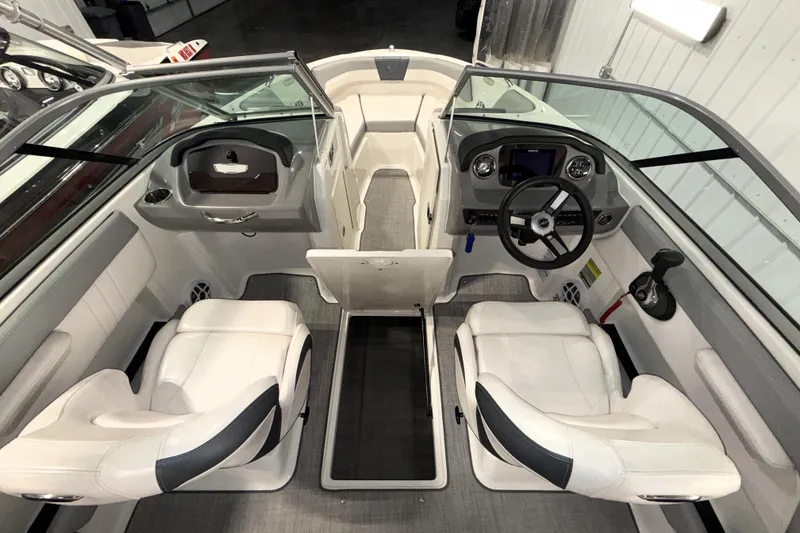 Slide: The Image of 2021 Chaparral 21 SSi boat interior with dual white seats and modern dashboard. - 6