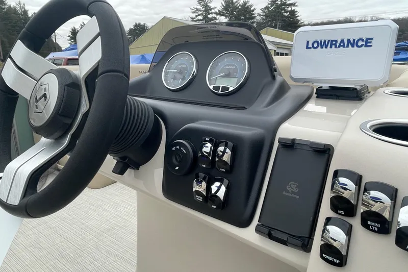 Slide: The Image of Steering console of 2026 Harris Cruiser 230 with Lowrance navigation system. - 11