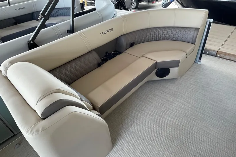 Slide: The Image of Luxurious seating on 2026 Harris Cruiser 230 pontoon boat, featuring beige upholstery and cup holders. - 15