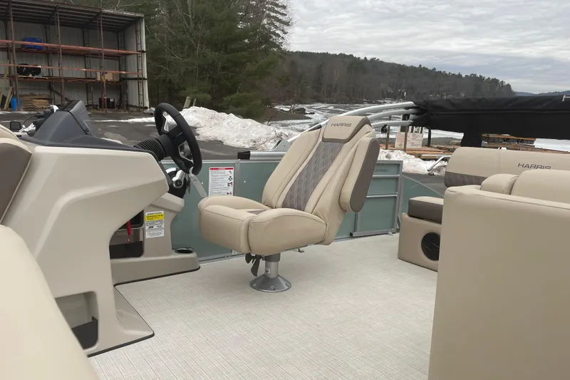Slide: The Image of 2026 Harris Cruiser 230 boat interior with beige seating and steering wheel. - 6