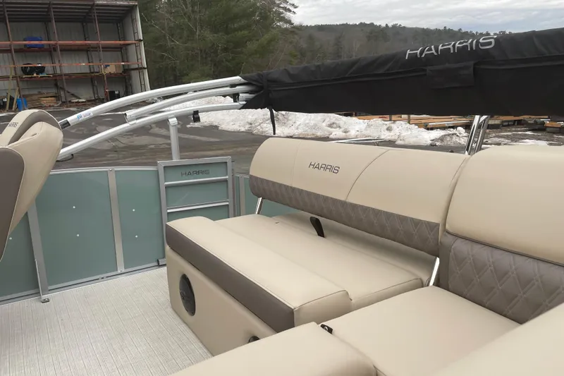 Slide: The Image of 2026 Harris Cruiser 230 boat interior with beige seating and covered canopy. - 7