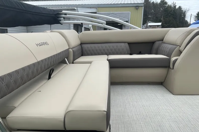 Slide: The Image of 2026 Harris Cruiser 230 boat interior with beige and gray seating. - 9