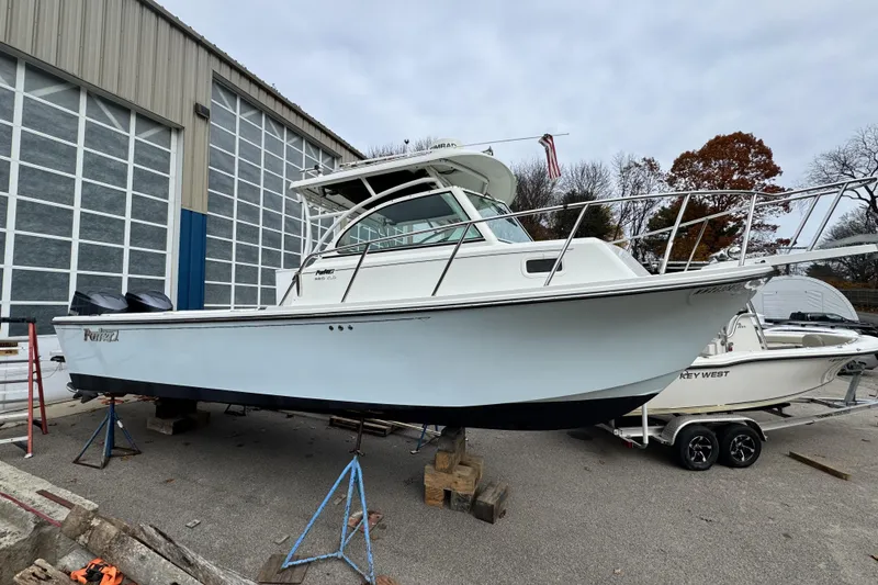 Slide: The Image of 2017 Parker 2810 XLD Walkaround boat helm with steering wheel and navigation controls. - 2