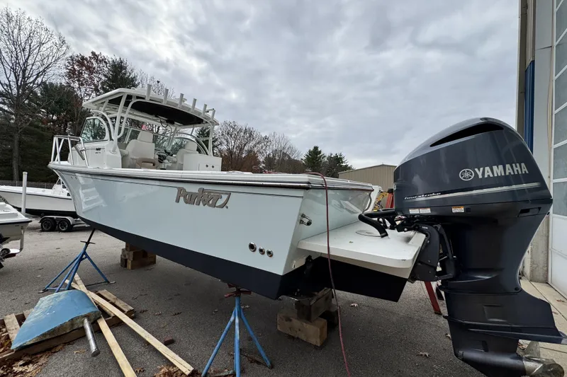 Slide: The Image of 2017 Parker 2810 XLD Walkaround boat hull supported by stands and wooden blocks. - 8