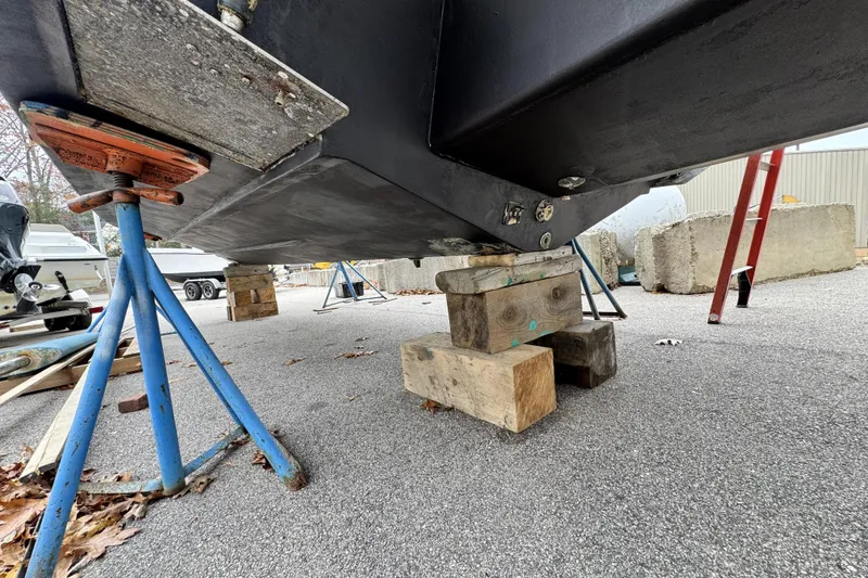 Slide: The Image of 2017 Parker 2810 XLD Walkaround boat on stands, viewed from below, near a storage facility. - 9