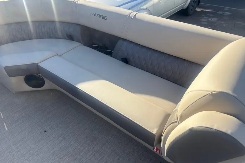 Slide: The Image of 2026 Harris Cruiser 230 boat interior with beige seating and cup holders. - 7