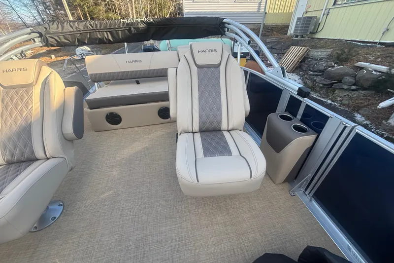 Slide: The Image of 2026 Harris Cruiser 230 interior with luxurious seating and cup holders. - 9