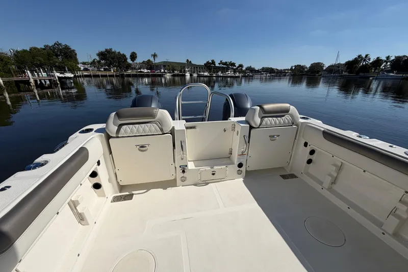 Slide: The Image of 2022 World Cat 255 DC boat interior with spacious seating and scenic waterfront view. - 13