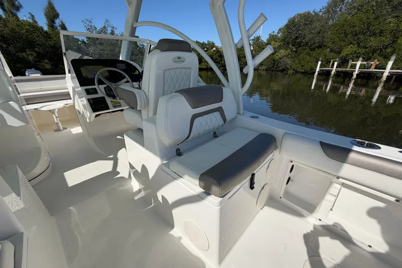 Slide: The Image of 2022 World Cat 255 DC boat interior with helm, seating, and water view. - 15
