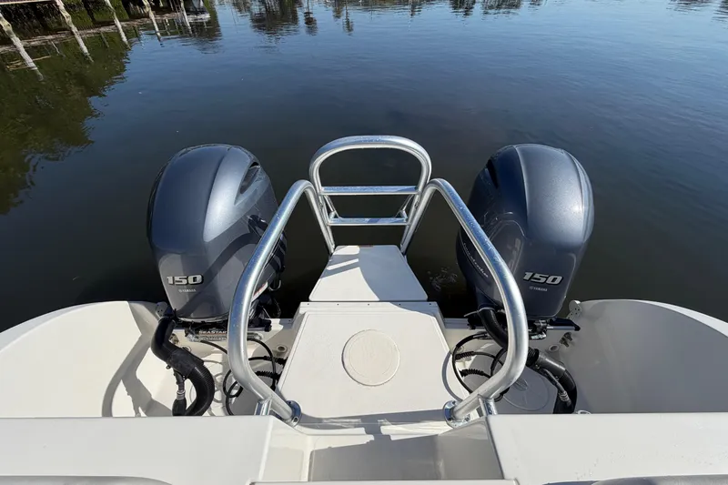 Slide: The Image of 2022 World Cat 255 DC boat with dual Yamaha 150 engines on calm water. - 16