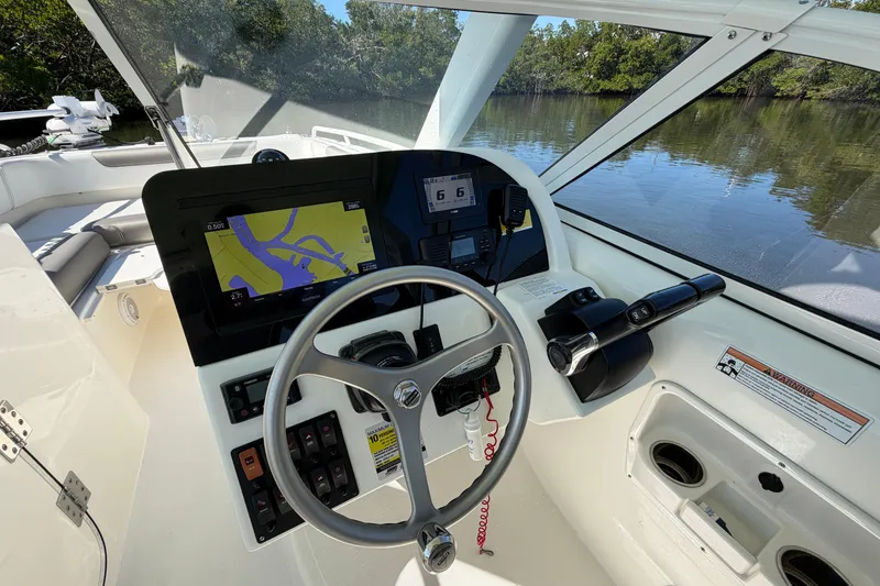 Slide: The Image of 2022 World Cat 255 DC boat cockpit with navigation system and steering wheel. - 17