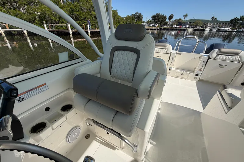 Slide: The Image of 2022 World Cat 255 DC boat interior with luxurious seating and helm station. - 19