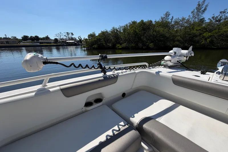 Slide: The Image of 2022 World Cat 255 DC boat interior with seating and fishing equipment on a sunny day. - 8