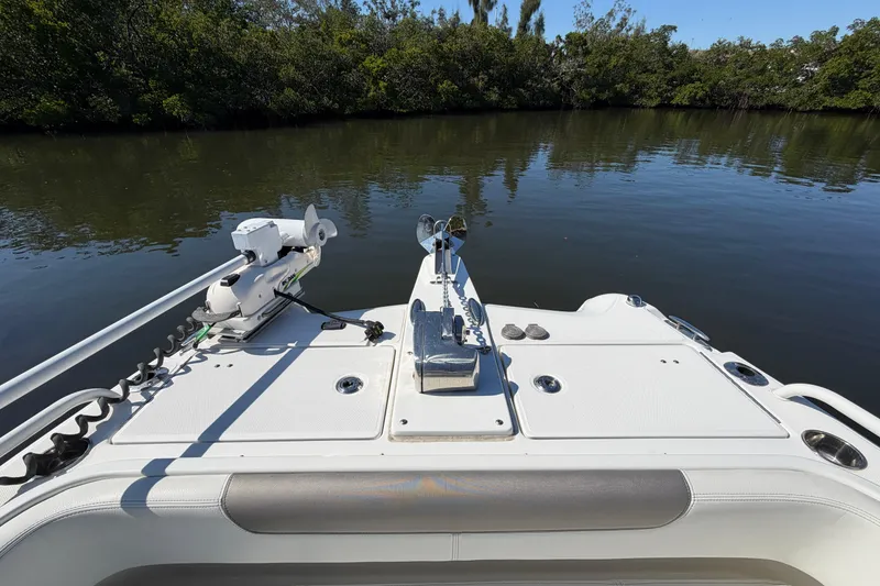Slide: The Image of 2022 World Cat 255 DC boat deck with trolling motor on calm water. - 9