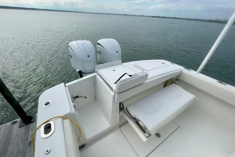 Slide: The Image of 2023 Regulator 28 Forward Seating boat with dual engines on calm water. - 16