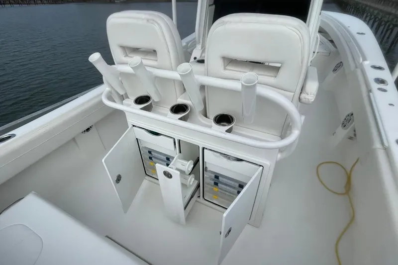 Slide: The Image of 2023 Regulator 28 Forward Seating boat interior with rod holders and storage compartments. - 18