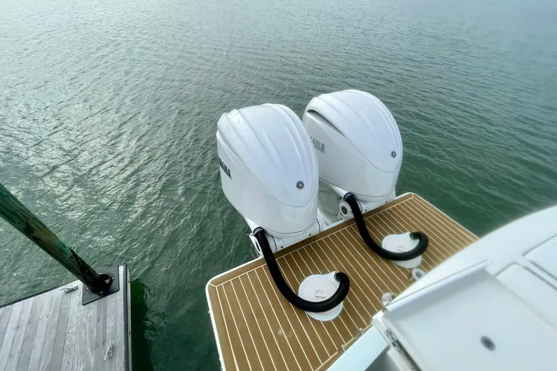 Slide: The Image of 2023 Regulator 28 Forward Seating boat with twin Yamaha outboard engines on water. - 19