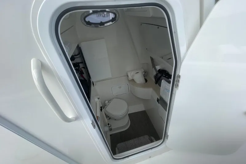 Slide: The Image of 2023 Regulator 28 Forward Seating boat interior with compact bathroom amenities. - 20