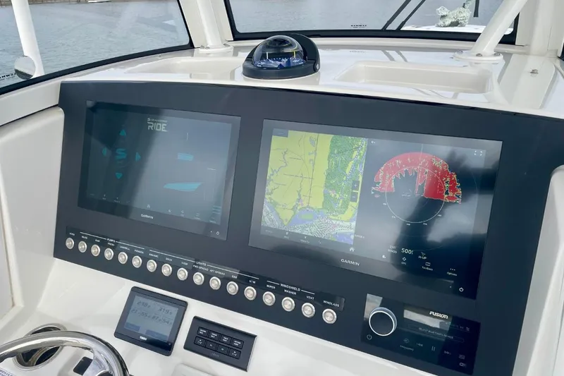 Slide: The Image of 2023 Regulator 28 Forward Seating boat dashboard with Garmin navigation displays. - 21