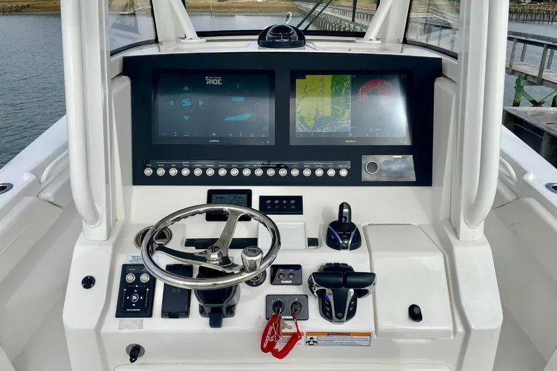 Slide: The Image of 2023 Regulator 28 Forward Seating boat dashboard with advanced navigation displays and controls. - 22