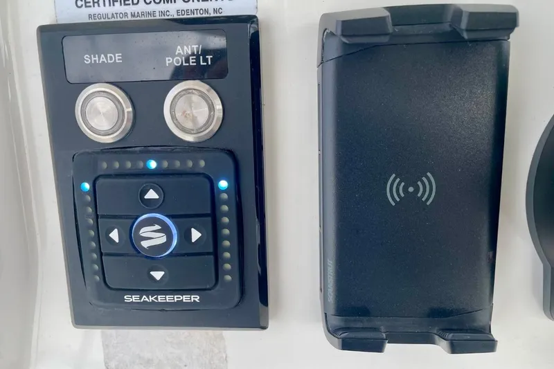 Slide: The Image of Control panel and wireless charging pad on 2023 Regulator 28 Forward Seating boat. - 24