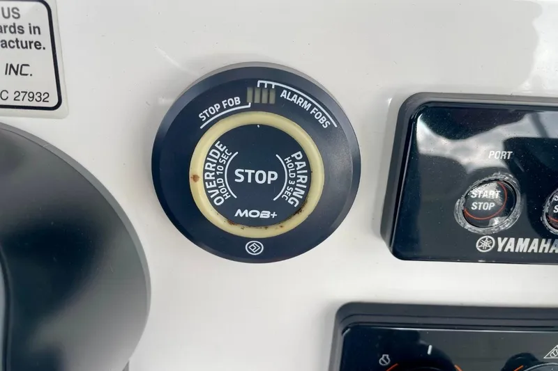 Slide: The Image of Control panel of 2023 Regulator 28 Forward Seating boat with Yamaha start-stop buttons. - 25