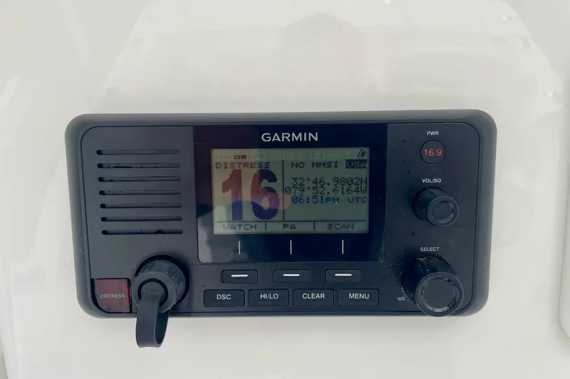 Slide: The Image of Garmin marine radio on 2023 Regulator 28 Forward Seating boat, displaying distress channel. - 30