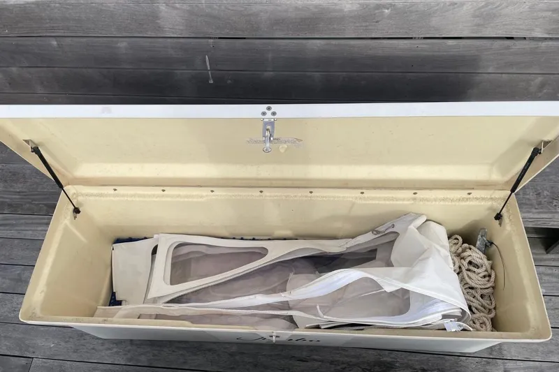 Slide: The Image of Open storage compartment on 2023 Regulator 28 Forward Seating boat with ropes and canvas inside. - 32