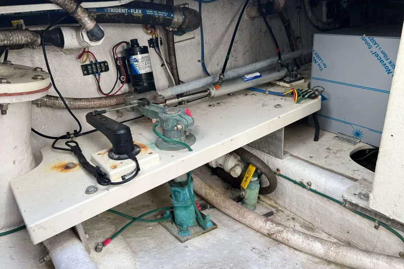 Slide: The Image of Engine compartment of a 2003 Henriques Yachts 35 Sportfisherman, showing mechanical components and wiring. - 11