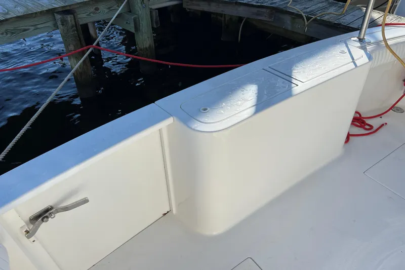 Slide: The Image of 2003 Henriques Yachts 35 Sportfisherman deck with storage and dock view. - 13