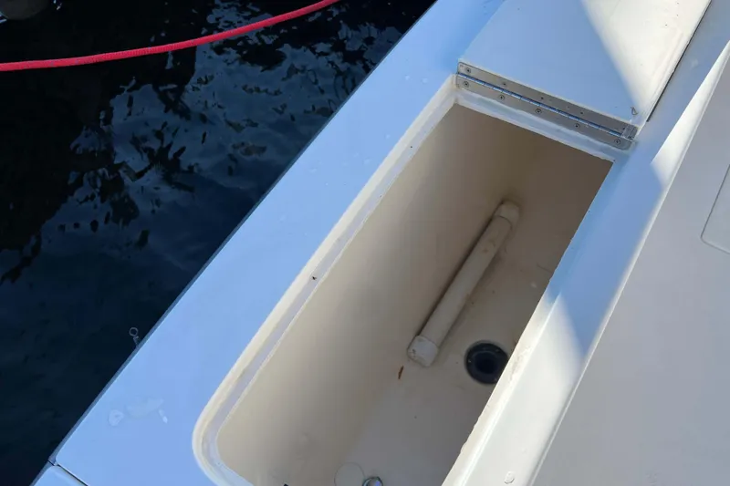Slide: The Image of Open storage compartment on 2003 Henriques Yachts 35 Sportfisherman, dockside view. - 14