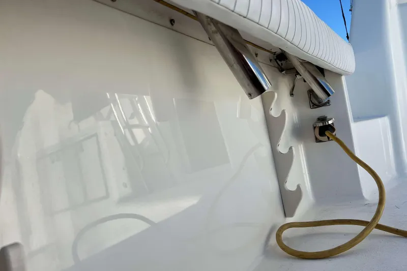 Slide: The Image of 2003 Henriques Yachts 35 Sportfisherman deck detail with rod holders and cable connection. - 16