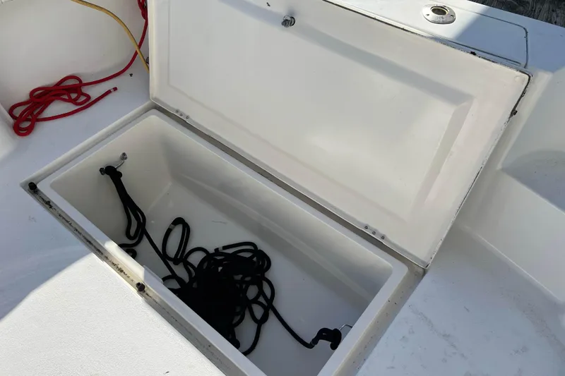 Slide: The Image of Open storage compartment on 2003 Henriques Yachts 35 Sportfisherman with coiled ropes inside. - 19