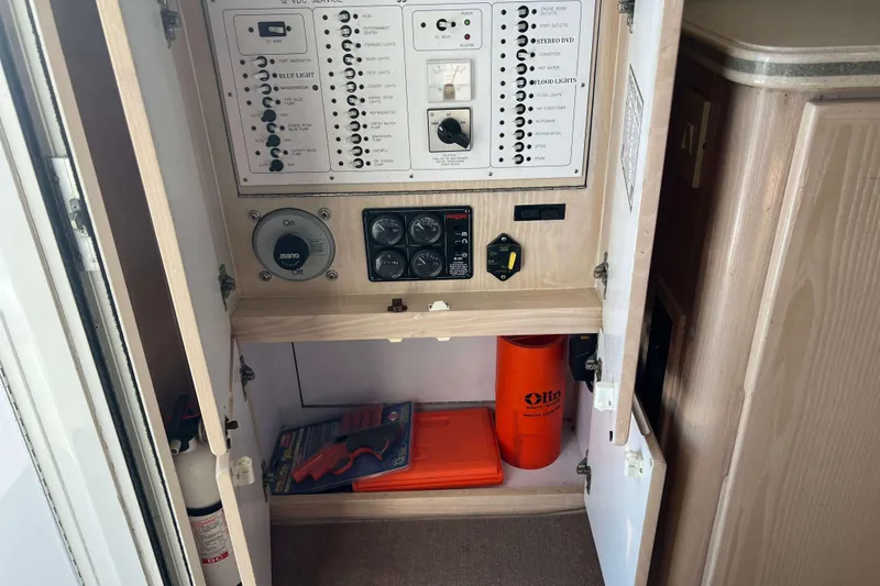 Slide: The Image of Electrical panel inside 2003 Henriques Yachts 35 Sportfisherman, featuring switches and safety equipment. - 25