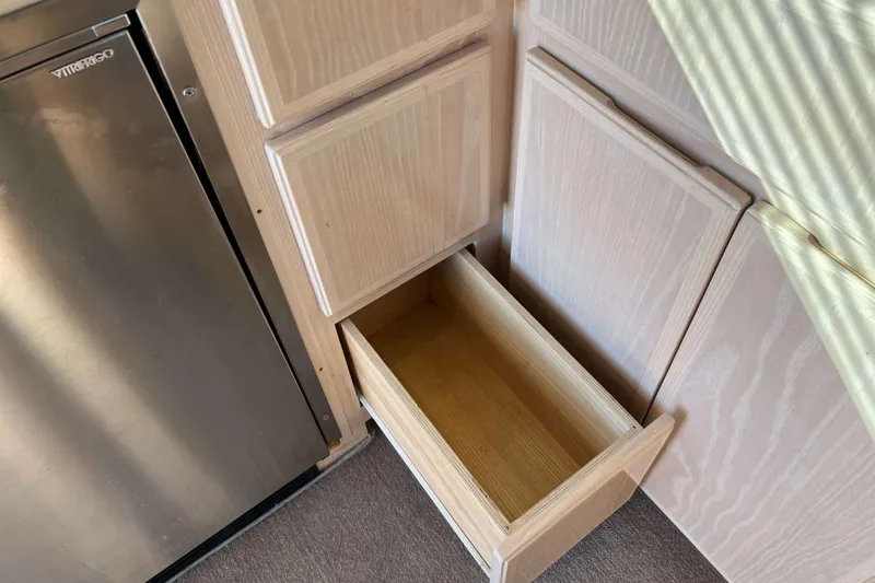 Slide: The Image of Open wooden drawer and stainless steel fridge in 2003 Henriques Yachts 35 Sportfisherman. - 28