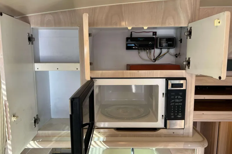 Slide: The Image of 2003 Henriques Yachts 35 Sportfisherman interior with microwave and open cabinets. - 31