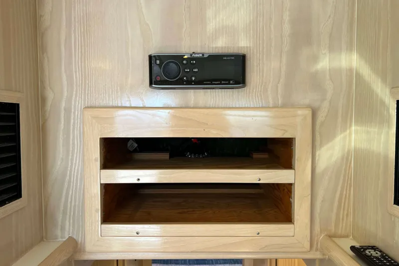 Slide: The Image of Interior of 2003 Henriques Yachts 35 Sportfisherman with wooden shelves and audio system. - 32