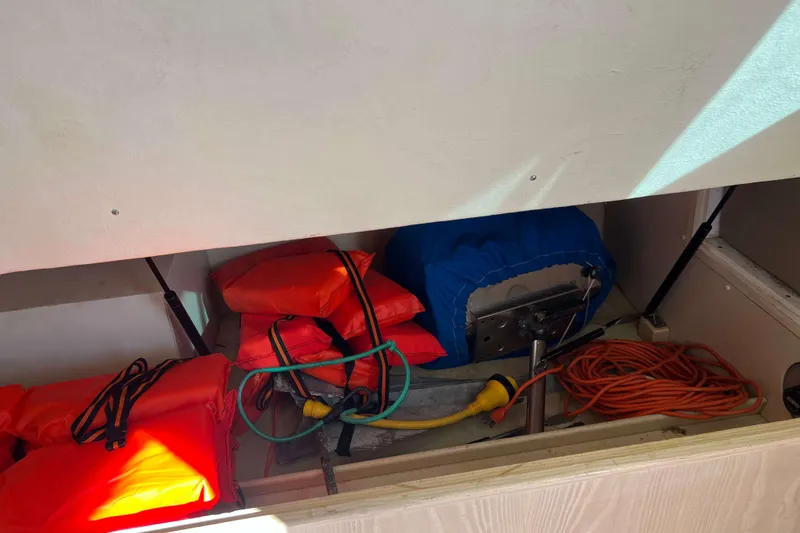 Slide: The Image of Storage compartment in a 2003 Henriques Yachts 35 Sportfisherman with life jackets and cables. - 35